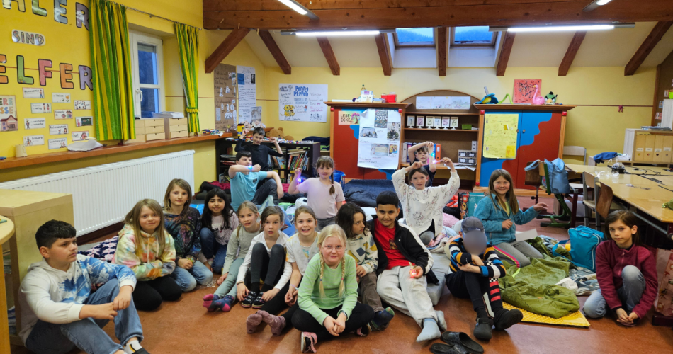 Klassenfoto. Kinder sitzen in einem Klassenzimmer auf dem Boden